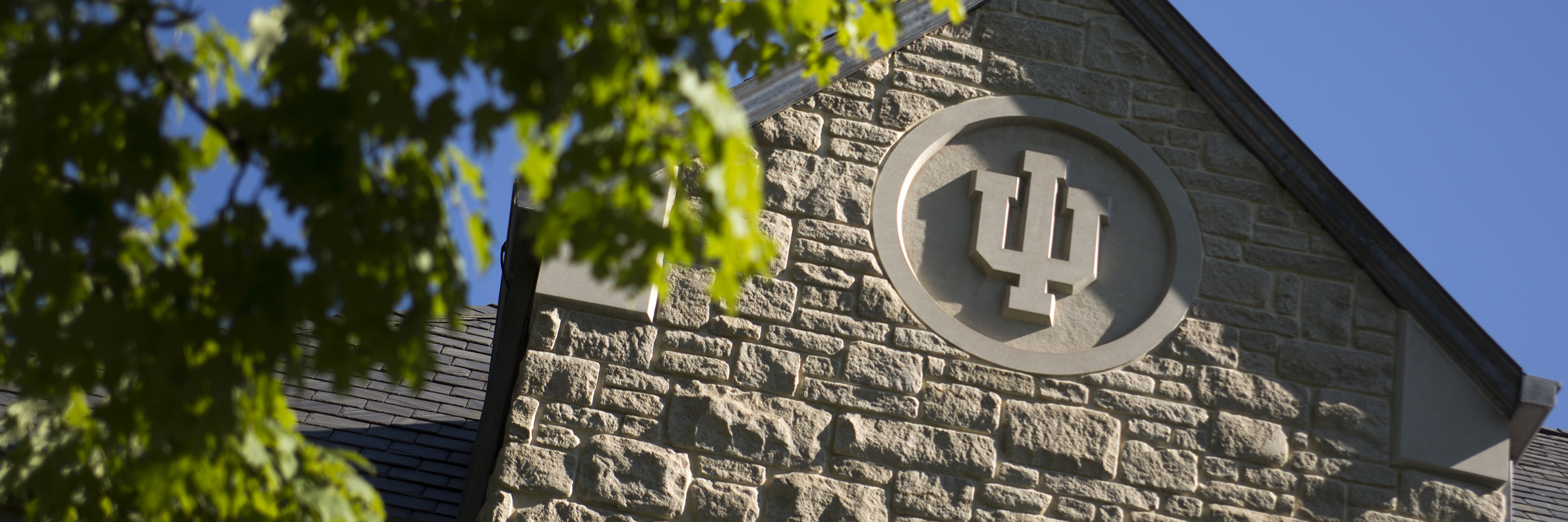 Indiana University seal carved into the side of a building