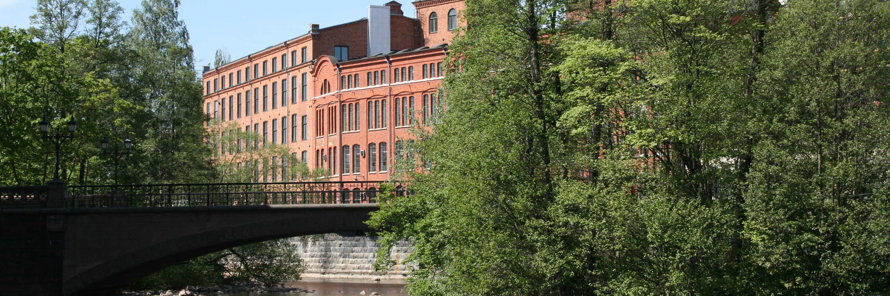 red building with trees and bridge